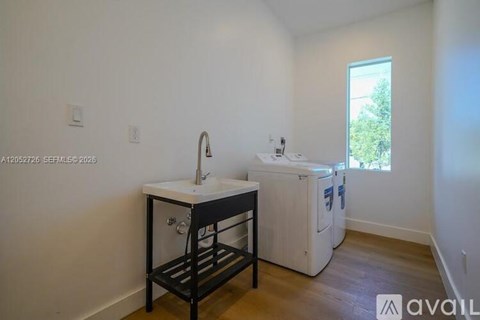 A small kitchen with a sink and a dishwasher.