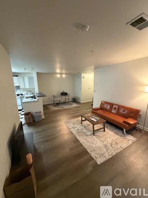 A living room with a brown couch and a coffee table.