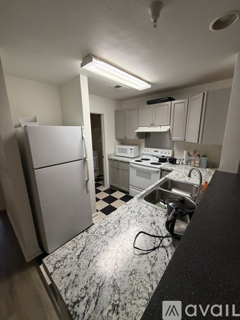 A kitchen with a black and white checkered floor.