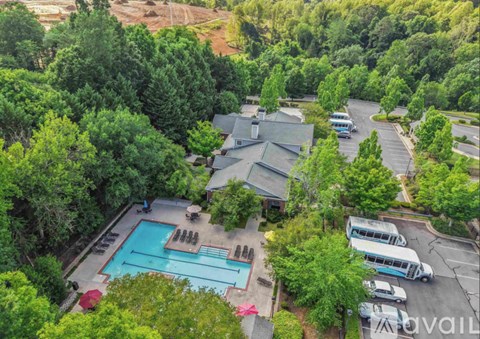 A bird's eye view of a resort with a swimming pool and a parking lot.