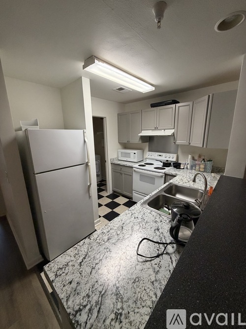 A kitchen with a black and white checkered floor.