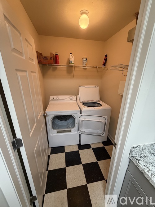 A small laundry room with a washer and dryer.