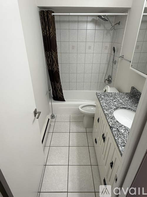 A bathroom with a toilet, sink, and shower.