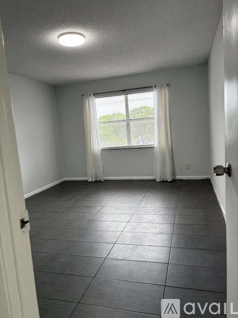 A room with a window and a door.