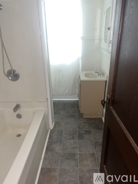 A bathroom with a tub, sink and toilet.