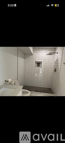 A bathroom with a white sink and a shower with a glass door.
