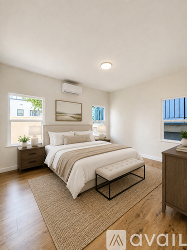 A bedroom with a large bed and a window overlooking the water.