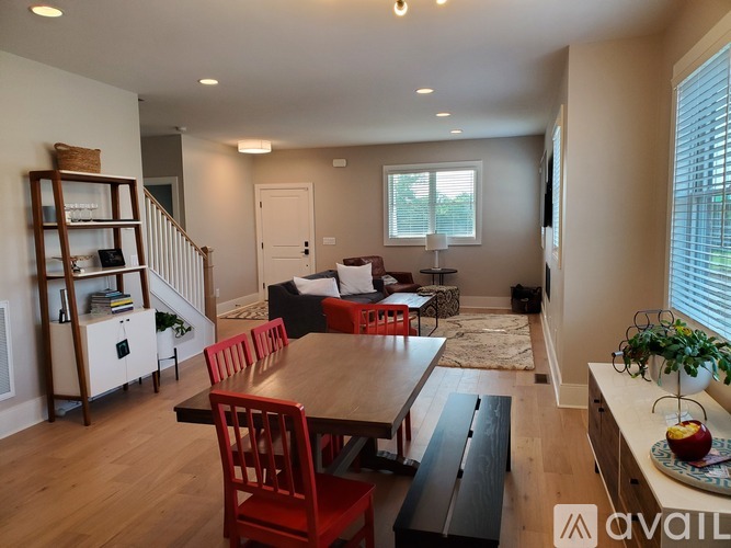 A living room with a dining table and chairs.