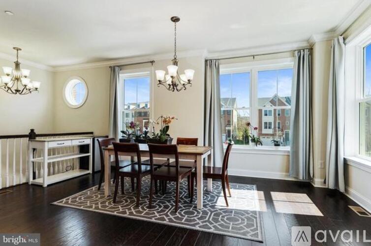A dining room with a table set for four.