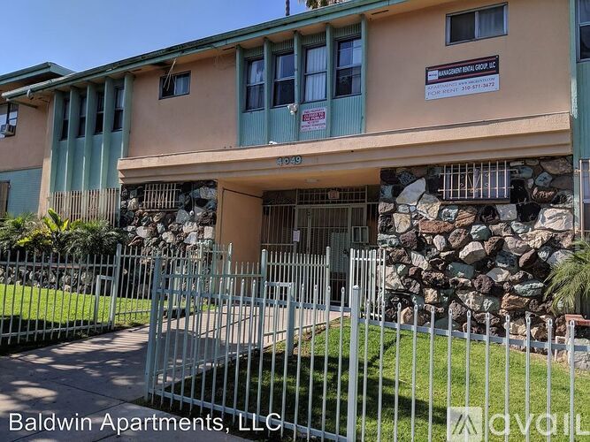 A building with a sign that says Baldwin Apartments, LLC.