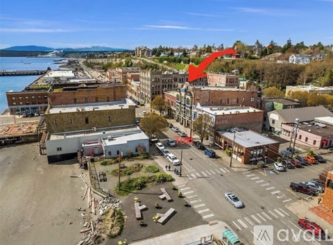 A red arrow points to a building in a city.