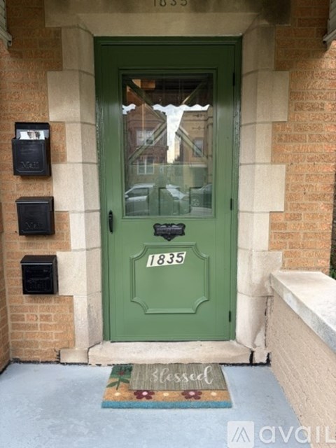 A green door with the number 1835 on it.