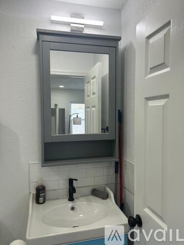 A bathroom sink with a mirror above it.