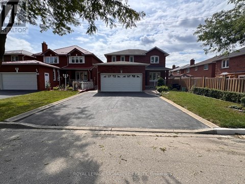 A large, two-story house with a red roof and white garage doors.