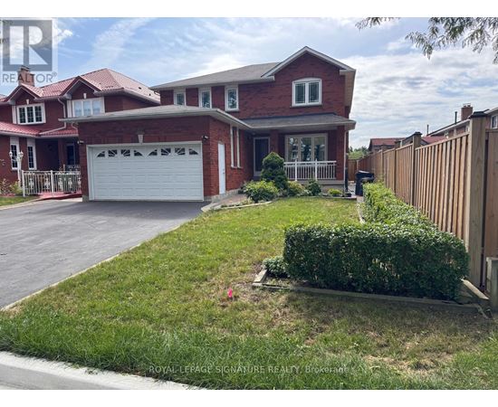 A red brick house with a white garage door is for sale.