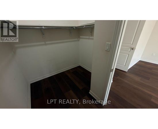 A room with a wooden floor and white walls.