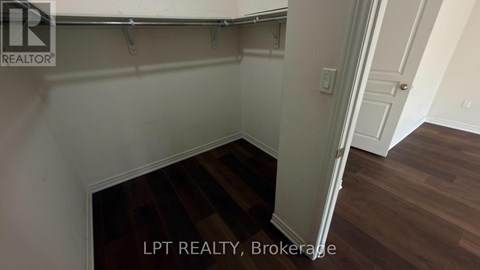 A room with a wooden floor and white walls.