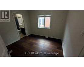 A room with a window and wooden flooring is for sale.