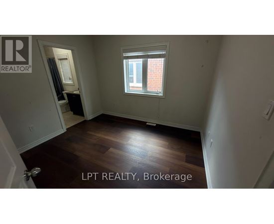 A room with a window and wooden flooring is for sale.