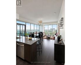 A modern kitchen with a large island and a view of the city.