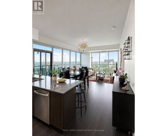 A modern kitchen with a large island and a view of the city.