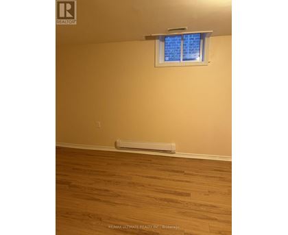 A room with a window and a radiator on the floor.