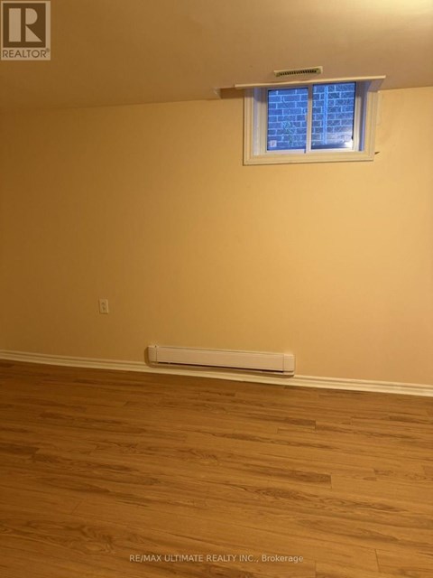 A room with a window and a radiator on the floor.