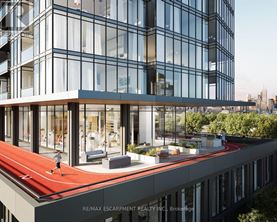 A modern building with a red running track on the roof.