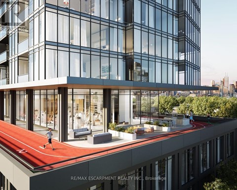 A modern building with a red running track on the roof.