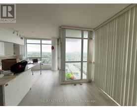 A room with a sliding glass door leading to a balcony.