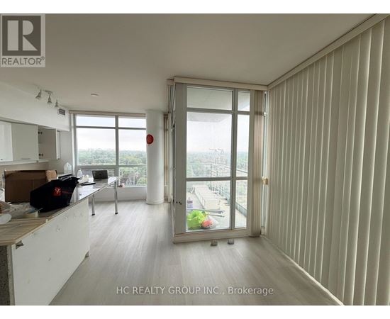 A room with a sliding glass door leading to a balcony.