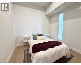 A bedroom with a large bed and a window.