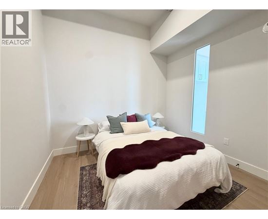 A bedroom with a large bed and a window.