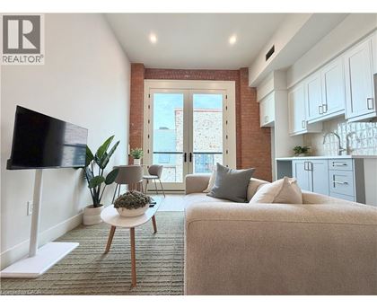 A living room with a couch, a table, and a television.