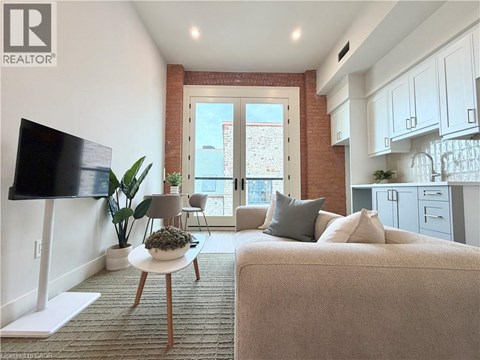 A living room with a couch, a table, and a television.