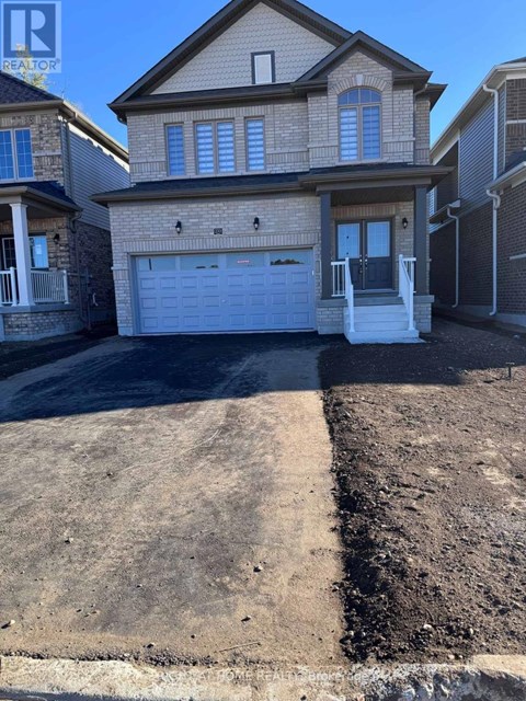 A house with a garage and a driveway in front of it.