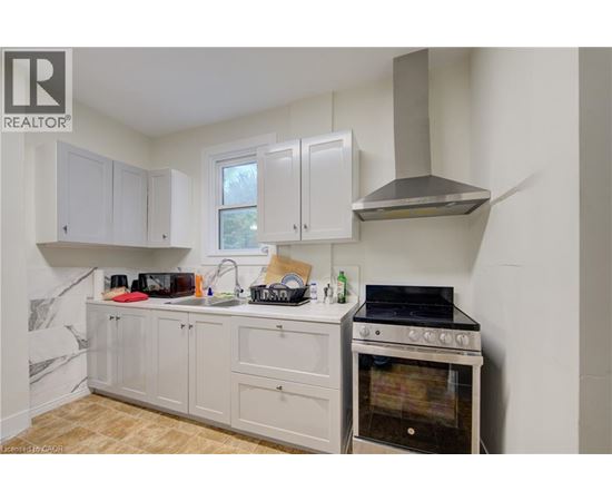 A kitchen with a stove and cabinets.