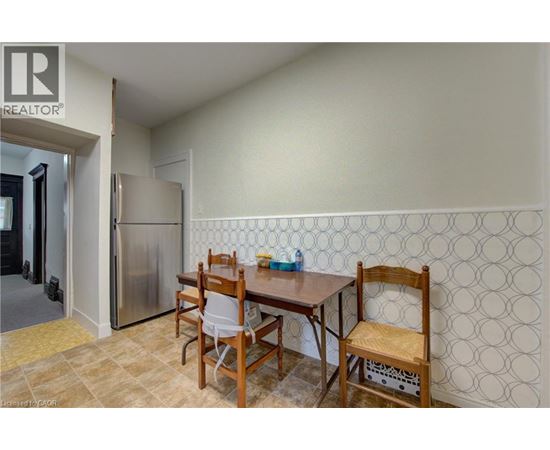 A dining room with a table and chairs.