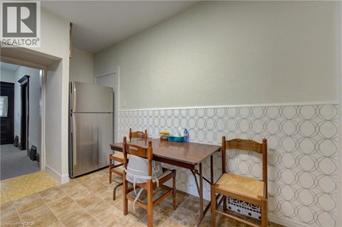 A dining room with a table and chairs.