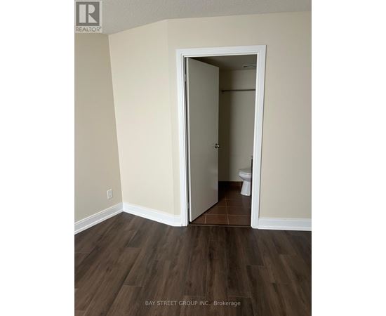 A room with a doorway leading to a bathroom.