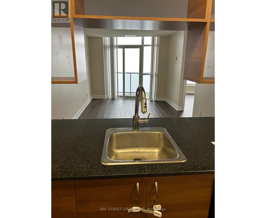 A kitchen with a sink and a window.