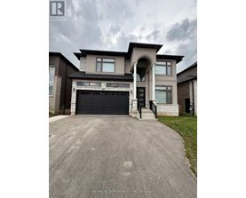 A large, modern house with a garage is for sale.
