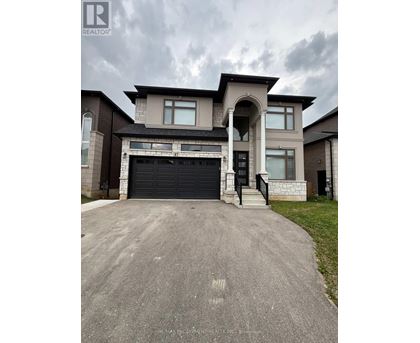 A large, modern house with a garage is for sale.