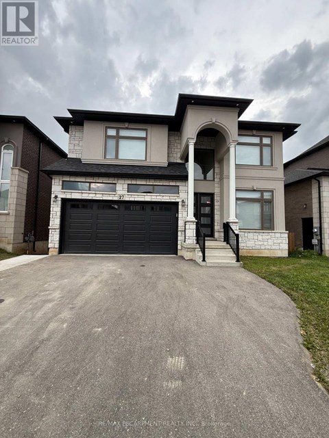 A large, modern house with a garage is for sale.