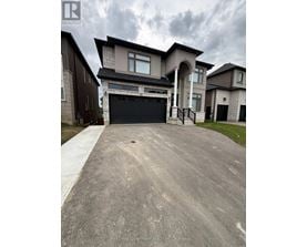 A large house with a driveway in front of it.
