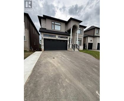 A large house with a driveway in front of it.