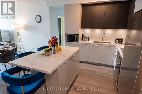 A kitchen with a table and chairs in front of a counter.