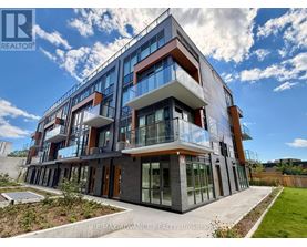 A modern multi-story building with balconies and glass windows.