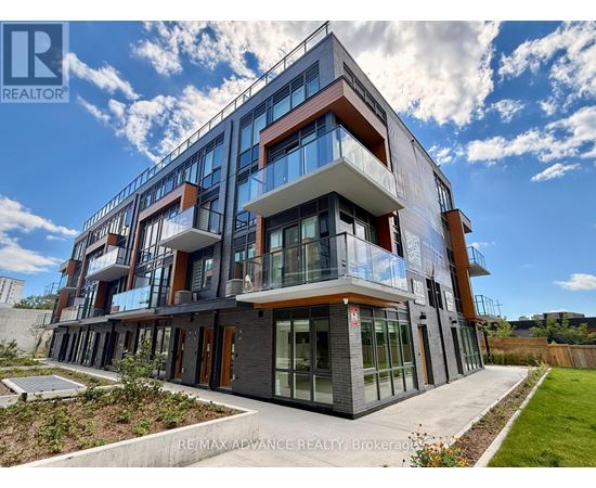 A modern multi-story building with balconies and glass windows.
