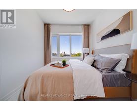 A bedroom with a large bed and a view of the city through the window.